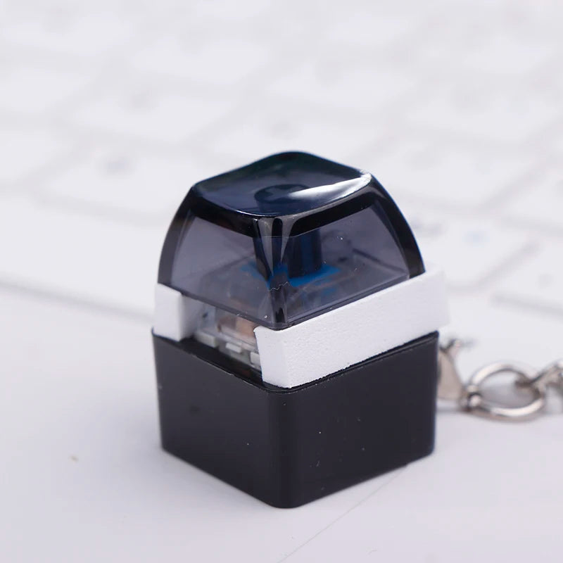 Mini mechanical keyboard switch keychain on a keychain ring