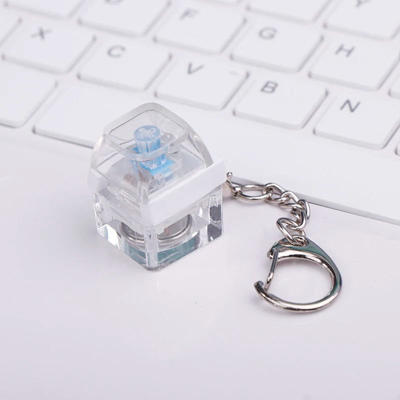 Pocket-sized single-key mechanical fidget toy held in hand